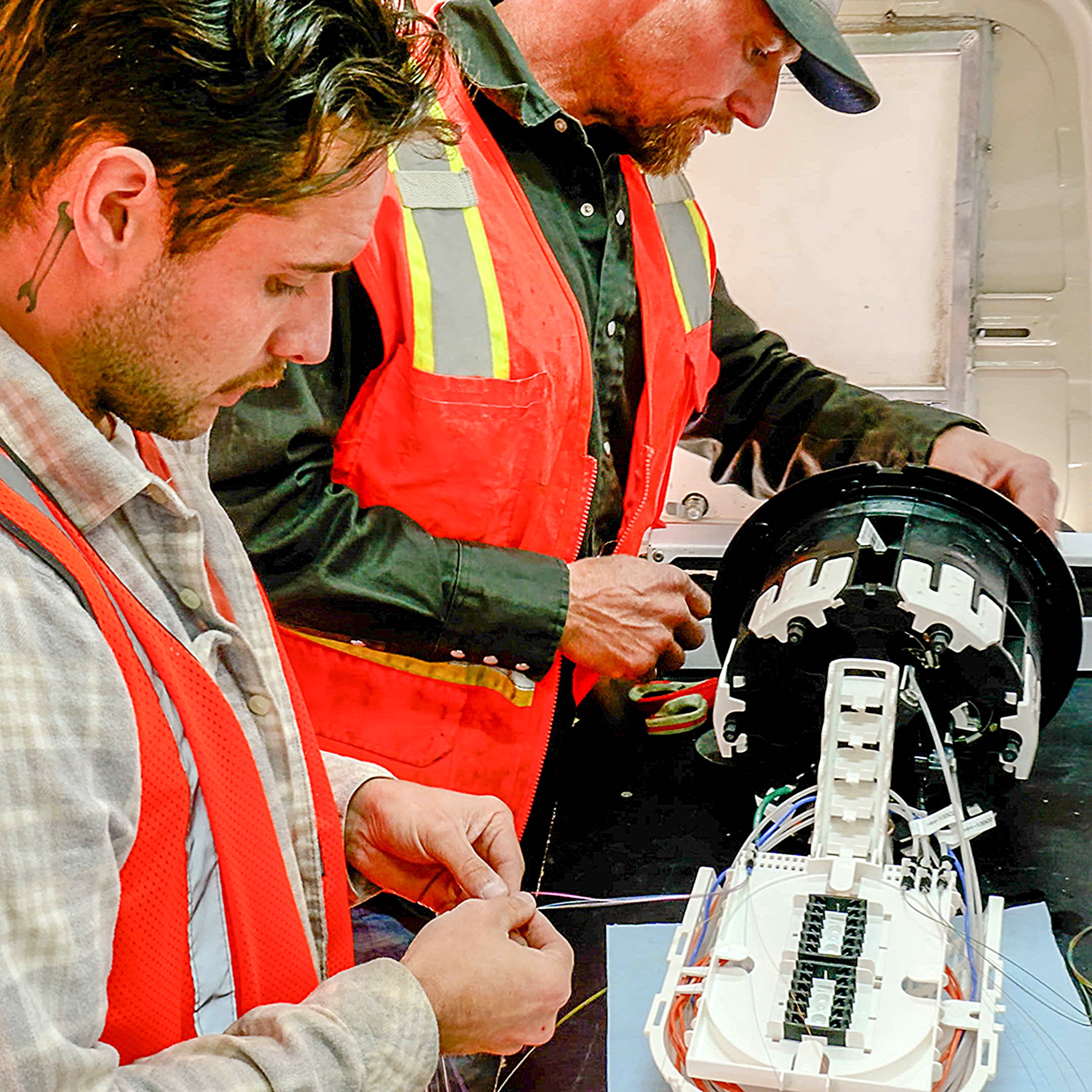 Two men splicing fiber