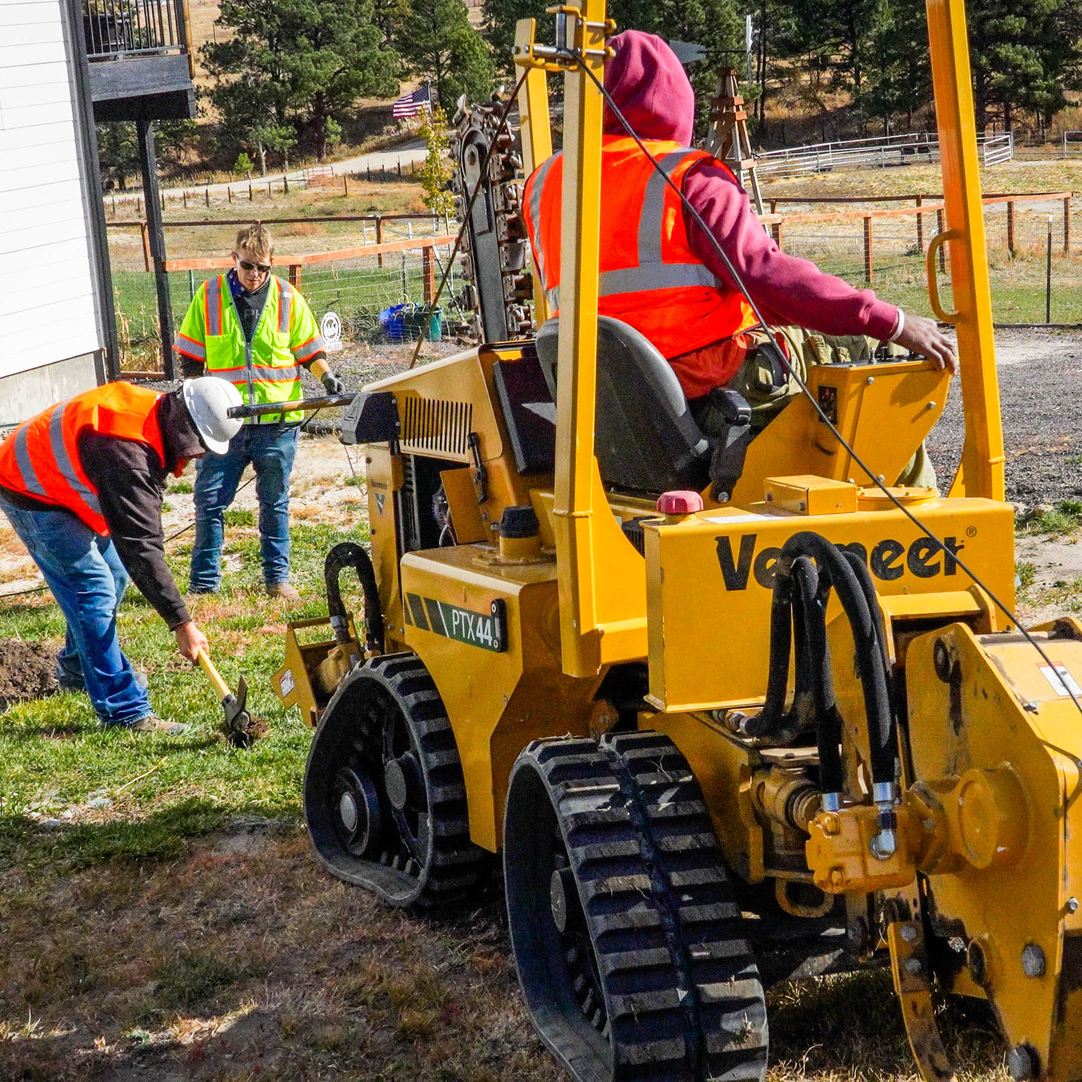 Construction crew driving a tractor and digging