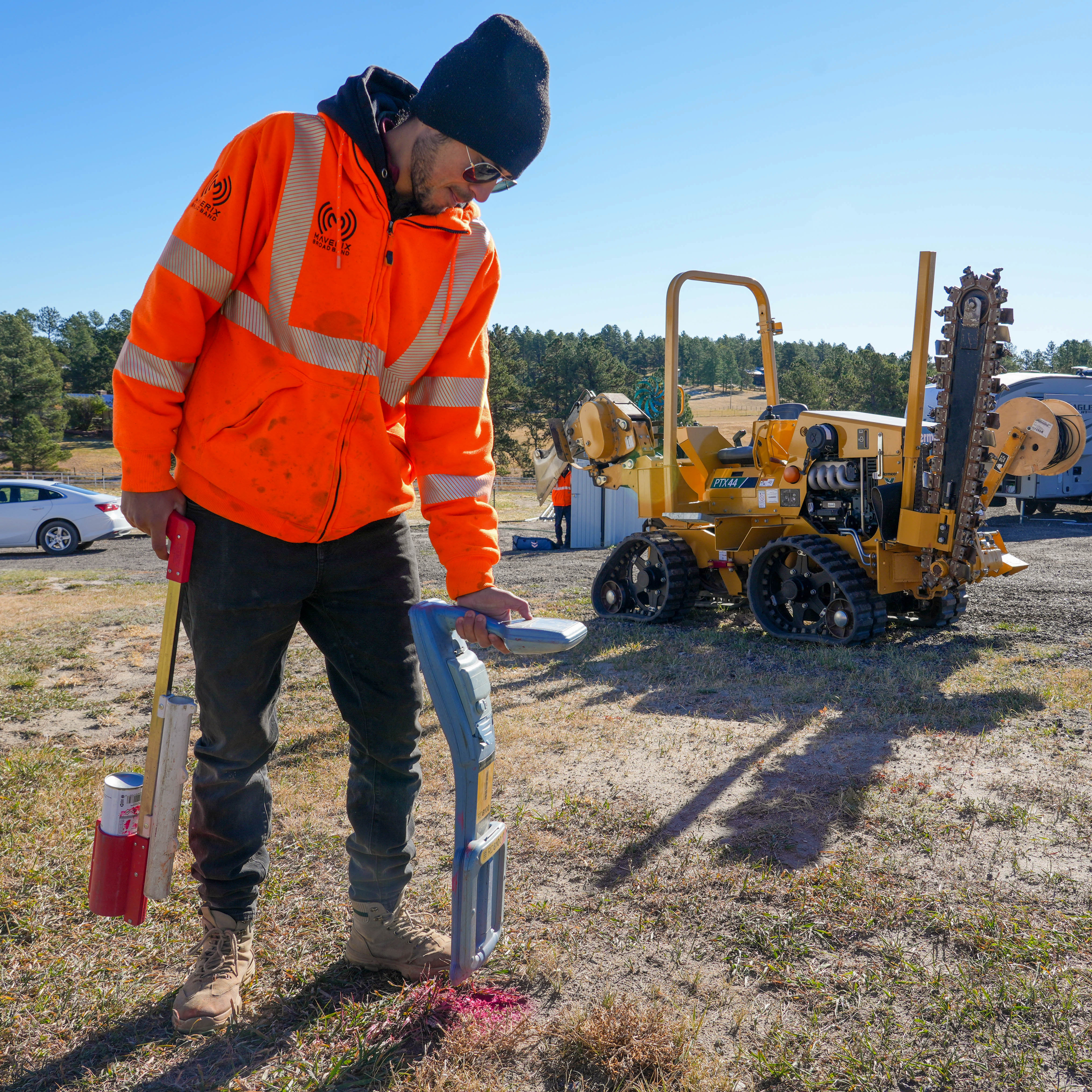 Man spraying paint on grass to mark utilities