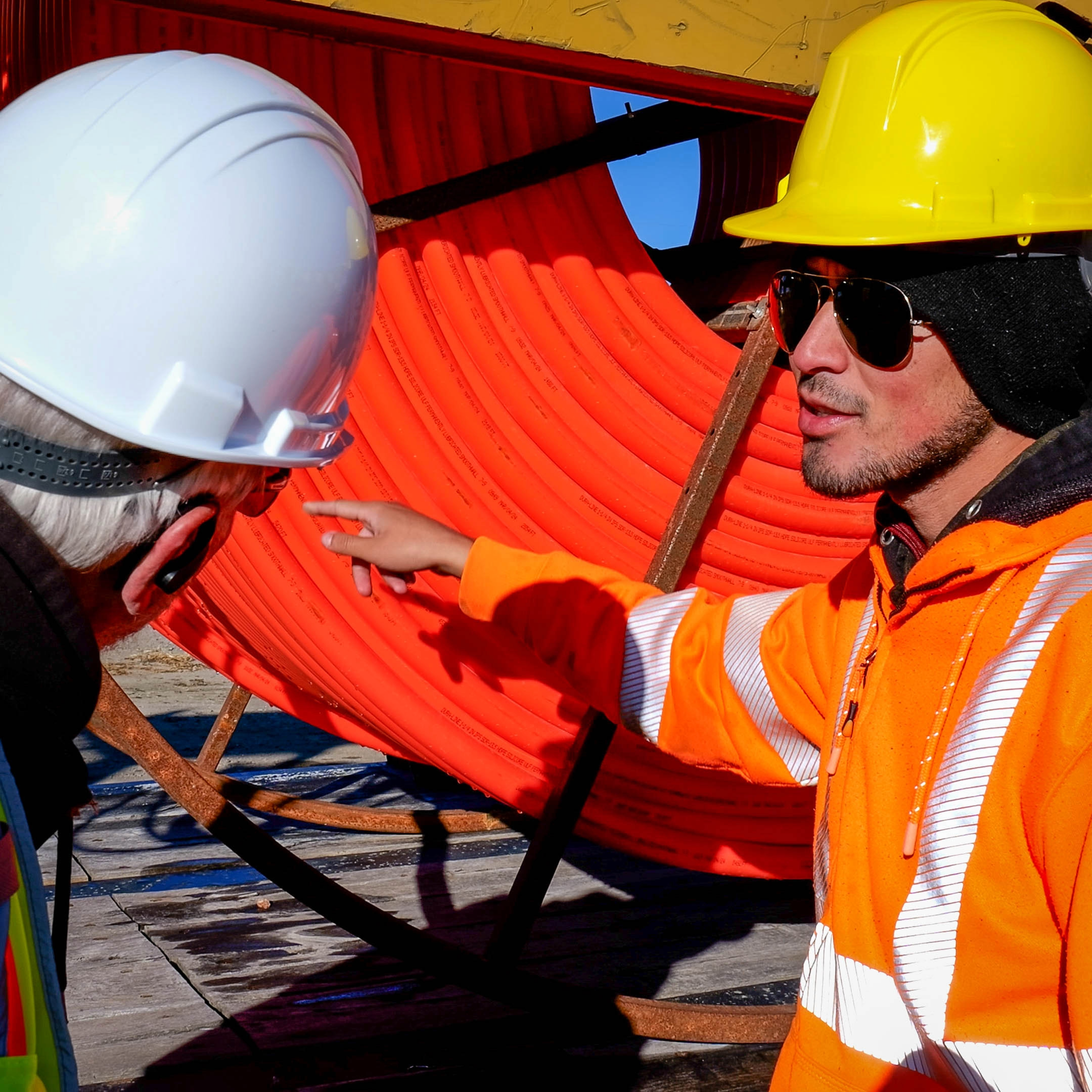 Men inspecting broadband conduit