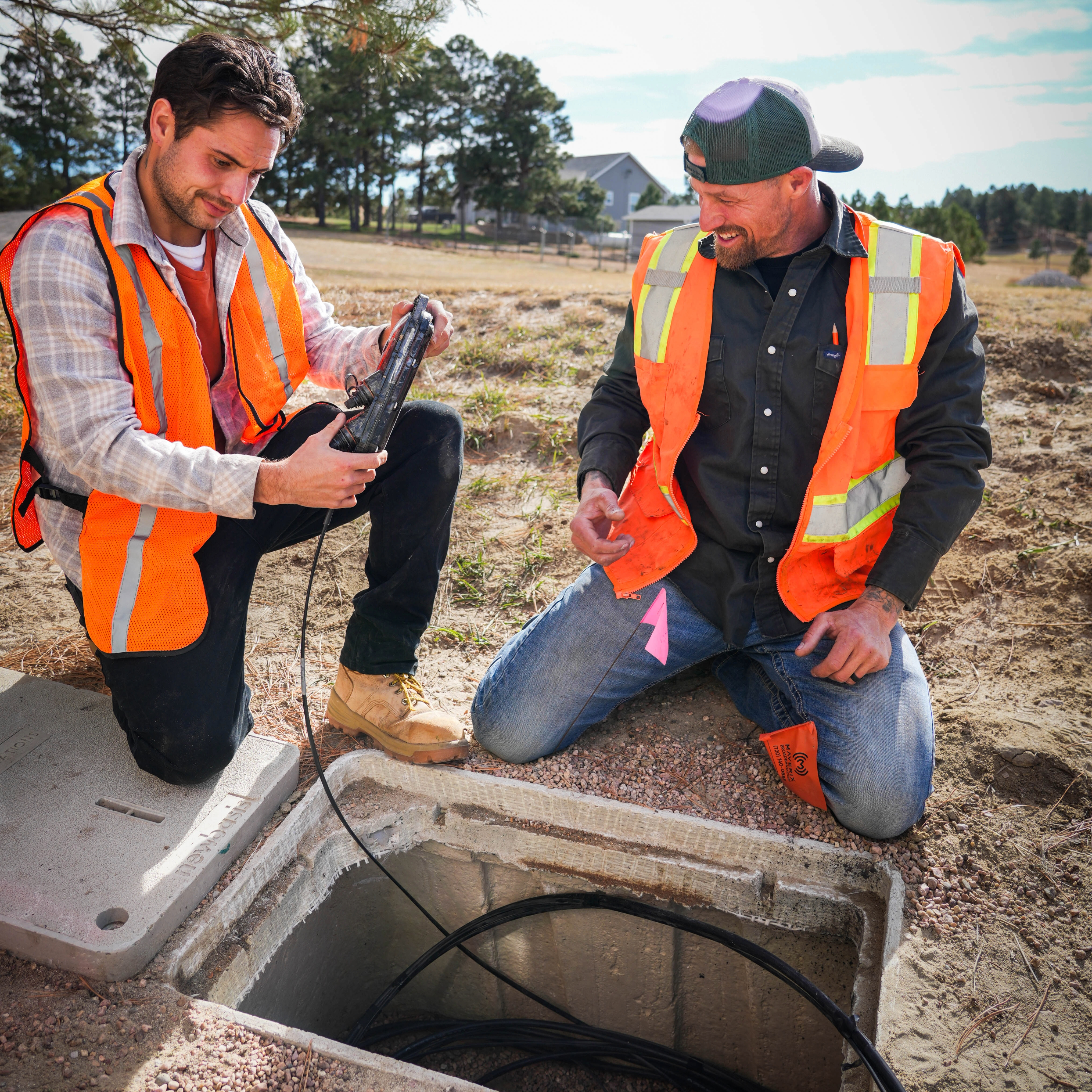 Men working on cables in underground box