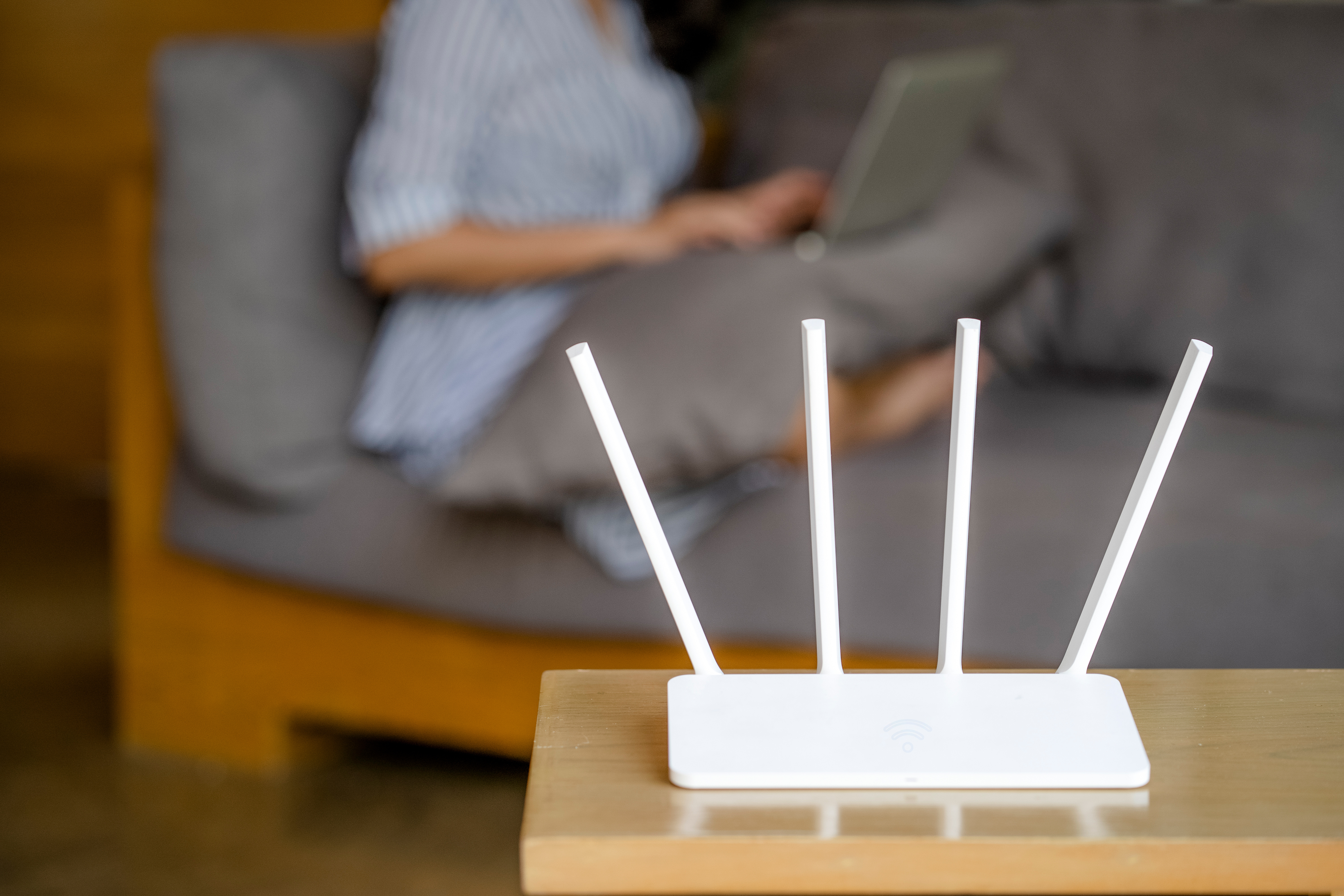 Woman working with Wifi router next to her